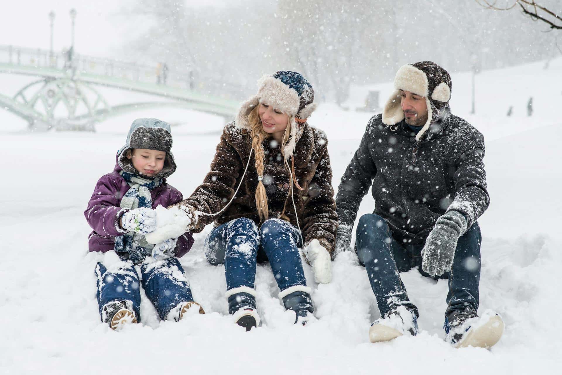 Family sitting outside in snow