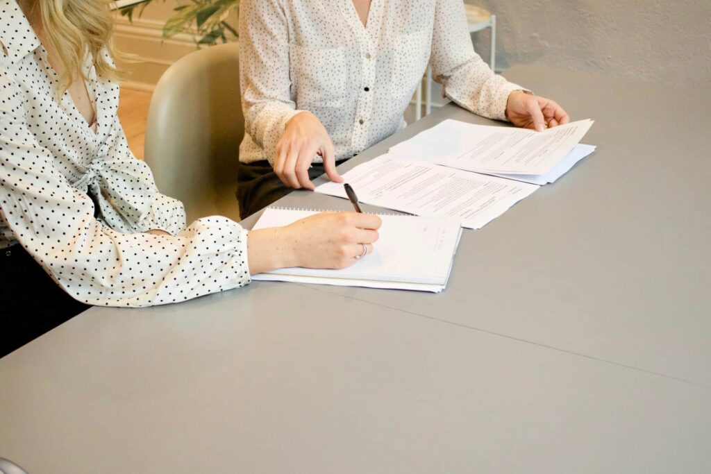 A female lawyer and a client signing papers