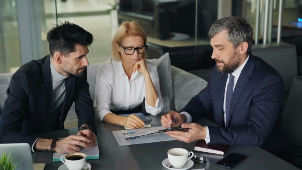 Financial advisor and couple sitting around a table